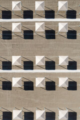 Perfect geometry of shadows and umbrellas on a deserted beach seen from above