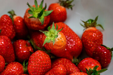 Juicy strawberry on a plate.	