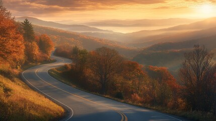 Naklejka premium A scenic mountain highway at sunrise, with golden light illuminating the curves of the road and surrounding valleys.
