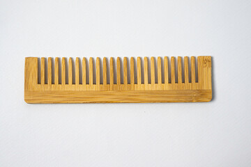 Wooden comb isolated in white background. use eco-friendly products for sustainability