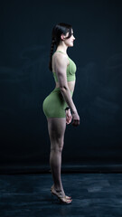Obraz premium Young beautiful woman with athletic body on dark background. Fitness girl 
