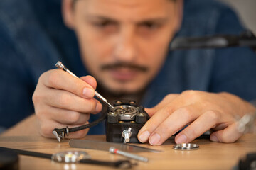 man performing a precision repair on a watch
