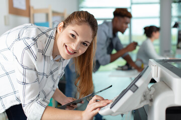 happy young woman on printer maintenance