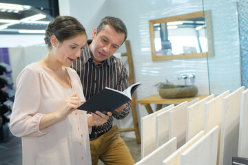 couple looking a tiled bathroom