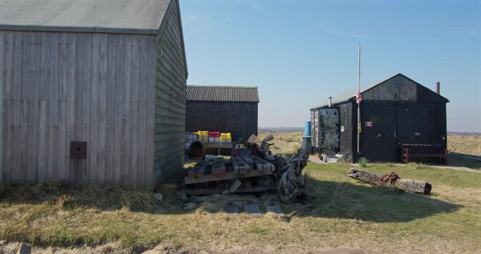 Panning Shot of fishing huts on winterton dunes next to Winterton on Sea,
