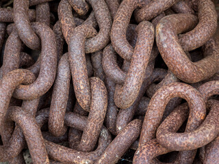 Closeup of old rusty iron links of a chain for use as a background