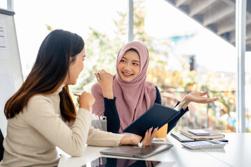 Teamwork process. Successful colleagues work and discuss their goals and plans together in an...