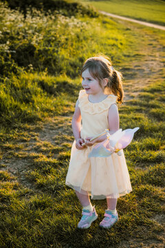 Toddler girl playing with a windmill
