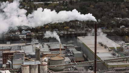 Aerial view of factory with smokestacks and emissions, Maine © Cavan