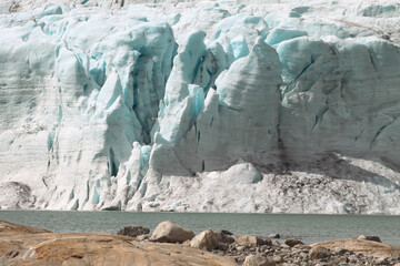 Pillars of blue ice lean at the face of Austdalsbreen glacier