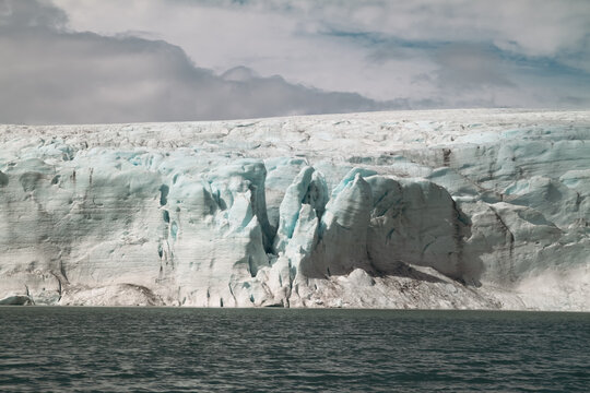 Dramatic view of part of glacier falling into the sea in Norway