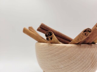 Aromatic pieces of cinnamon sticks in homemade bowl.