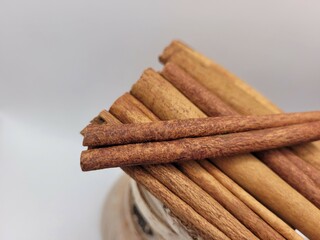 Aromatic cinnamon sticks on a creamy background.