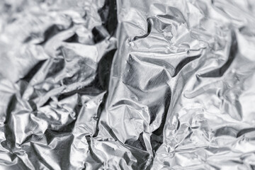 Crumpled silver-colored foil surface showcasing its intricate texture
