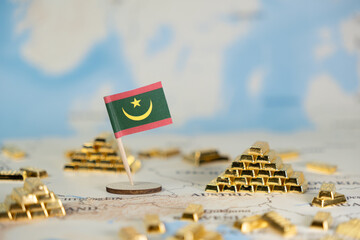 Mauritania flag standing on a map with gold bars, representing national wealth, economic strength,...