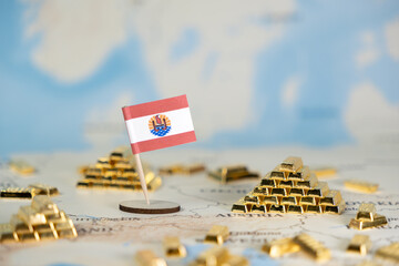 French Polynesia flag positioned on a world map surrounded by shining gold bars, symbolizing global...