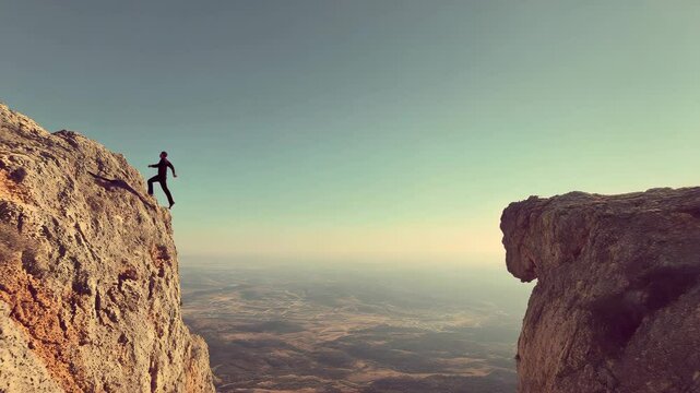 Adventurous person leaping between two rocky cliffs against clear sky. Freedom, daring moment. Bold leap, walking, flying. Courage, exploration, thrill. Adventure, outdoor activities, achievements.