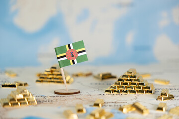 Dominica national flag on a world map with gold bars, symbolizing national economy, financial...