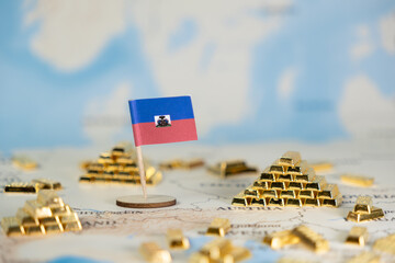 Haiti national flag stands proudly on a global map surrounded by shimmering gold bars, depicting...