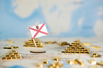 Jersey flag with miniature gold bars on map symbolizing offshore finance, economic autonomy, and...