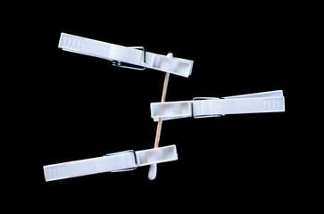 Creative composition of clothespins and cotton swab on black background