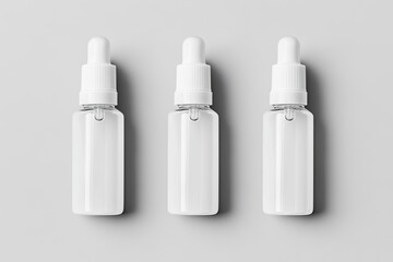 Three clear, white dropper bottles on a gray background
