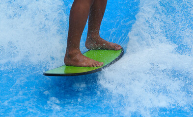 Feet control and balance a surfboard on the water
Surfing Simulator
