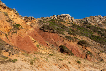 Fototapeta premium Telheiro beach at sunset in Sagres, Portugal, with its colorful cliffs.