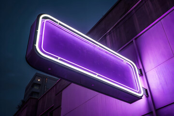 Purple neon sign on building at night