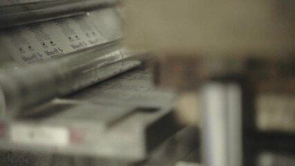 Labels being printed and applied in pharmaceutical packaging at production line.