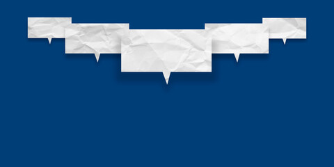 White speech bubble crumpled paper isolated on blue background