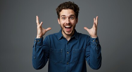 Excited man hands raised celebration victory success achievement happiness joy. Male curly hair blue shirt enthusiastic gesture triumph concept