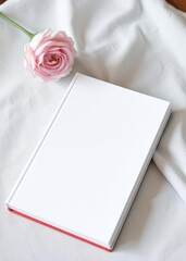 A white book with blank cover sits on top of the table. mockup. book mockup. 