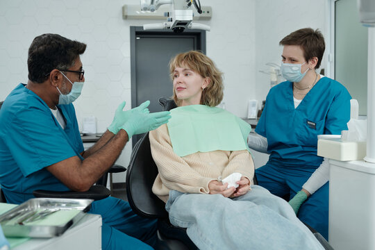 Dentist Giving Recommendations to Woman after Checkup