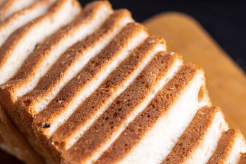 wholemeal bread on a board. Sliced Sourdough Bread isolated on white background, homemade bakery concept