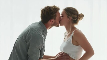 Moments of Anticipation: A tender scene captures a couple sharing a heartfelt kiss, with the woman's pregnancy subtly highlighted, creating a moment of joy, love. - Powered by Adobe
