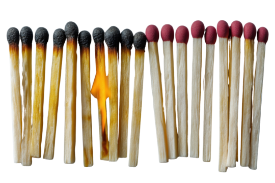 Burnt Matchsticks: A striking composition of burnt and unburnt matchsticks on surface symbolizes transformation, with the central matchstick ablaze, igniting change