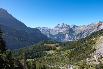 Obraz premium Mountain landscape in the Swiss Alps in the region of Kandersteg and Oeschinen Lake with a beautiful weather and a blue sky