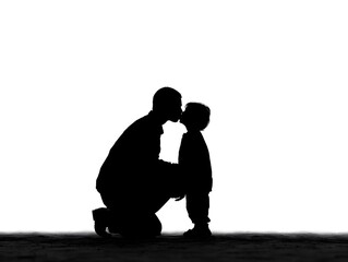 A loving father kneels down to gently kiss his adorable toddler son against a bright white background.