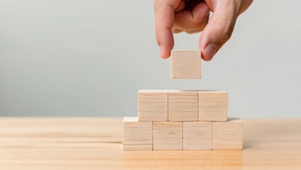 Wooden blocks stacking hand building blocks tower construction strategy concept