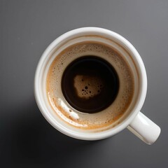 A white coffee mug with a small coffee stain on the rim, viewed from a top-down angle