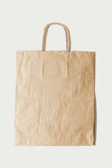 Paper bag. Kraft folded paper shopping bag on white