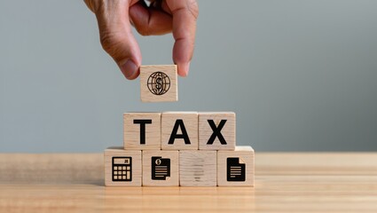 Tax concept with wooden blocks hand placing global tax block for tax planning tips