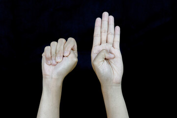 Fototapeta premium Unity Gesture Fist and Open Palm Hands Against Black.