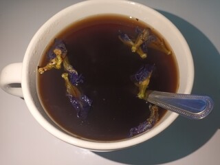 A white cup of coffee in the morning.