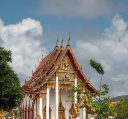 Captivating buddhist monk chants can be heard from some of the temoles of the Wat Chalong Temple,...