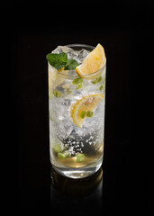 Iced Lemon and Mint Refresher with Citrus Slices on Black Background