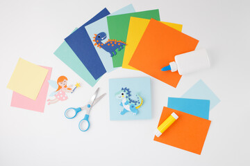 Colorful paper fairy and dragon with art materials on surface, ideal for kids DIY kits, toy...