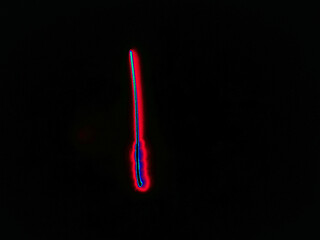 Glowing English letter I. On a black background with colored neon lines, a letter of the English alphabet is written by hand. The letter glows pink-red, creating a green-blue halo around it.