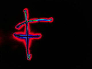 Glowing English letter F. On a black background with colored neon lines, a letter of the English alphabet is written by hand. The letter glows pink-red, creating a green-blue halo around it.